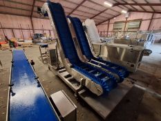 Twin belt rubber flighted swan neck conveyor.