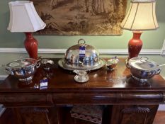 A selection of silver plated serving ware including claret jugs
