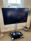 JVC television on mobile stand with DVD and video player