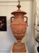 Pair of Terracotta Urns on wooden plinth. Urn dimensions circa. 1650mm by 700mm. Buyers please note