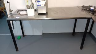 Stainless steel topped table 1,650 x 680 with Vogue can opener attachment – Located in side kitchen