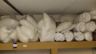 Assortment of bedding to top shelf – Located in staff laundry room