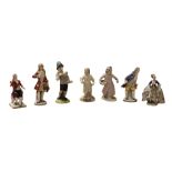 A collection of Continental and English Porcelain Miniature Figures, comprising a Chelsea red anchor