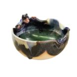 A Japanese Sumida Gawa pottery pond bowl, of irregular circular form, covered in flowing black, blue