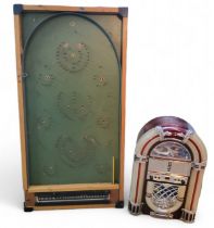 A Chad Valley bagatelle board, 77cm x 38cm;  a Sherwood Small free standing table top jukebox