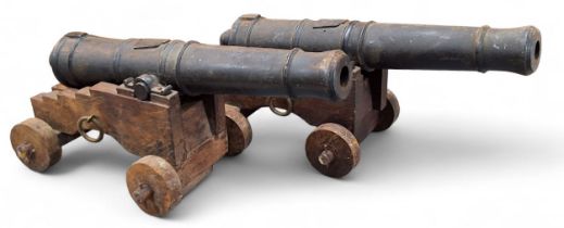 A pair of early 20th century model desk cannons, 27cm barrels, oak carriages
