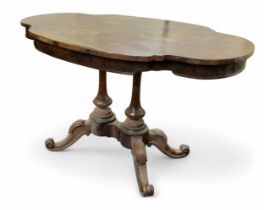 A Victorian rosewood shaped oval loo/centre table, quarter veneered top, twin turned columns, four