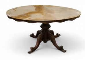 A Victorian walnut centre table, quarter veneered  oval top, shaped apron, bold turned columns,
