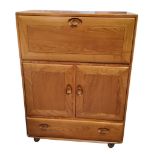 An Ercol  Windsor model 430 elm serving cabinet or drinks cabinet, with fall-front above double