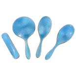 A George V silver and gulliouche enamel four piece dressing table set, various brushes and mirror,