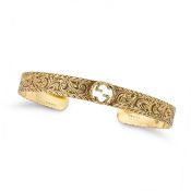 GUCCI, A GOLD CUFF BANGLE the open cuff bangle with the Gucci logo, engraved with foliate motifs,