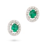 NO RESERVE - A PAIR OF EMERALD AND DIAMOND STUD EARRINGS each set with an oval cut emerald within