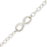 NO RESERVE - TIFFANY & CO., A SILVER INFINITY BRACELET comprising an infinity symbol on an oval link