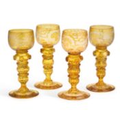 A SET OF FOUR BOHEMIAN AMBER GLASS HOCK GLASSES