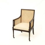A 19TH CENTURY MAHOGANY CANED BERGÈRE ARMCHAIR