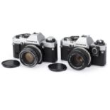 A Pair of Olympus OM-series 35mm SLR Cameras,