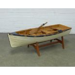 Rowing boat on stand, with blue and white painted hull, complete with a pair of oars, 120 x 37 x