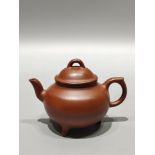 A rare, antique Yixing teapot, featuring a small piece with the inscription "Meng Chen" on the botto
