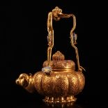 A treasured Qing Dynasty imperial court teapot, handcrafted with a carved gold monkey head design.