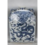 A Yuan Dynasty blue and white porcelain flat bottle with dragon and phoenix design.