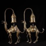 A pair of bronze camel palace lanterns with inlaid gold and inscriptions
