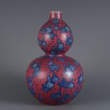 A gourd vase with blue and white porcelain and rouge-red ground, with a Fulu pattern, made during th