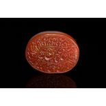 AN ISLAMIC CARVED CARNELIAN AGATE INTAGLIO SEAL.