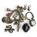 A sterling silver charm bracelet, a silver watch and a small selection of costume jewellery. The