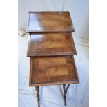 A Victorian mahogany canterbury on castors along with an Edwardian mahogany nest of three tables.