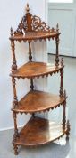 A Victorian walnut four tier corner wotnot with ornate shelf detail and pierced gallery top with