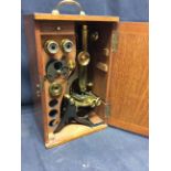 An early 20th Century antique microscope with accessories.