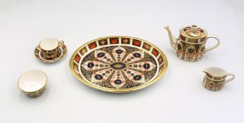 A Royal Crown Derby miniature tea set in the 1128 pattern consisting of a teapot, sugar bowl,