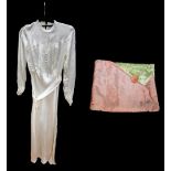 An off-white satin wedding dress from 1936 with pink tucked bodice, covered buttons, pie-crust