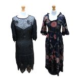 A mid 1950s dress with full skirt, scooped neckline, elbow length sleeves, navy with large pink/