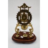 A 20th Century skeleton mantle 8 day clock on a mahogany base AF