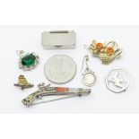 A collection of brooches including a Miracle rifle brooch inset with agate, a white metal (