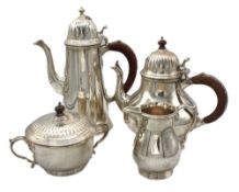 An Elizabeth II silver four piece tea set. comprising of globular tea pot with hardwood handle