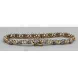 A 9 carat gold tennis bracelet set diamond chips. Closed length 9cm, gross weight 9gm