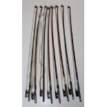 A bundle of eight violin bows. Various.