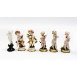 Three Capodimonte cherubs playing instruments with two other Neapolitan cherub figures and a