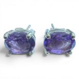 A pair of amethyst set ear studs. Featuring oval mixed cut amethysts measuring approximately 8mm x