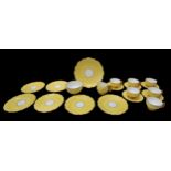 A 1930s Aynsley yellow ground with butterfly tea cup handle detail tea set comprising of biscuit