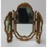 A mid 20th century gilt composite three glass folding toilet mirror, 66cm high