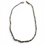 A fancy link bi-precious metal Albert watch chain. With a fob clasp stamped "18c" and a bolt clasp