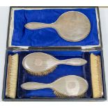 An early 20th century dressing table brush set, including silver mirror, measuring length 26cm