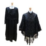 A black sateen Edwardian dress, c.1910. It has a jet-encrusted yoke, neckline edged in jet, cream/