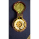 An unnamed 19th century circular gilt brass aneroid pocket barometer; with compass and thermometer