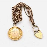 A 9ct medallion and chain, early 20th century with monogrammed reverse suspending from a hollow link