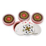 A collection of vintage promotional playing card decks in round plastic cases, circa 1970s