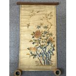 A Chinese embroidered silk scroll hanging, 19th century, brightly decorated with song birds in